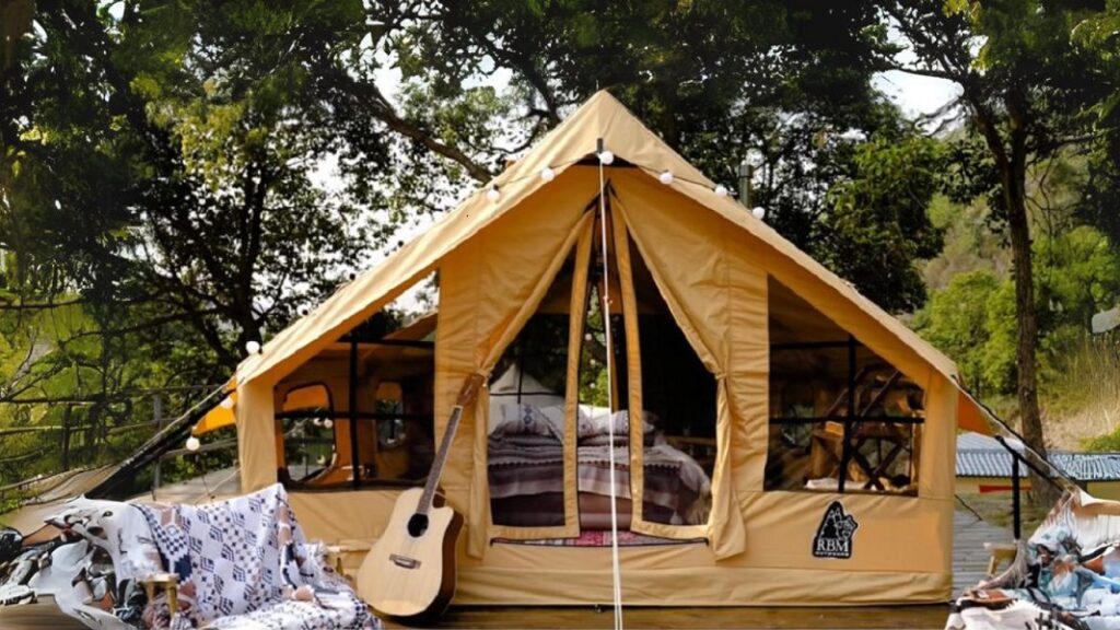 A beautiful inflatable house tent setup with a guitar placed at the entrance of the tent.