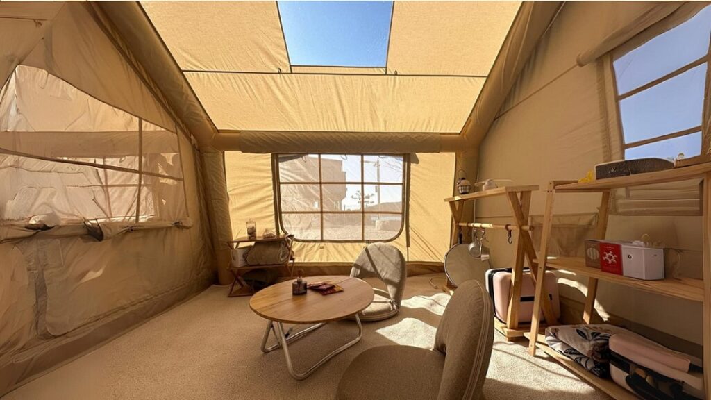 Inside view of a large inflatable tent with a table and chairs placed inside it.